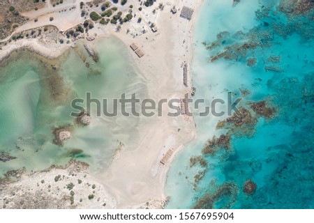 Aerial drone shot of beautiful turquoise beach with pink sand Elafonisi Crete Greece. Best beaches of Mediterranean Royalty-Free Stock Photo #1567695904