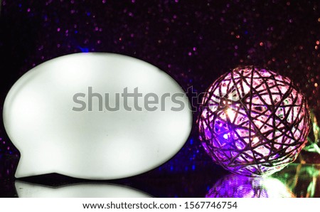 Luminous cloud for text on a purple background with a braided ball glowing next to it. Lamp in the form of a cloud for text with backlight