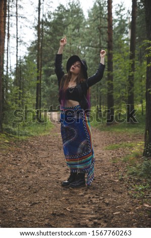 A child of nature or a girl of nature in the forest and plants. Hippie dancing