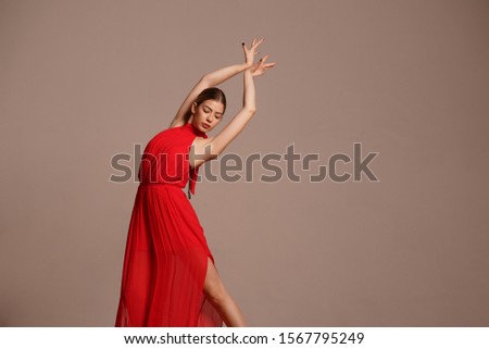 portrait of dancer girl in red dress in the dance studio