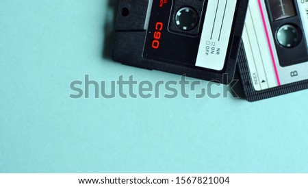 Audio cassette. Old rarity. Music on an old medium. Nostalgia, digitizing cassettes. For an 00s party. Royalty-Free Stock Photo #1567821004