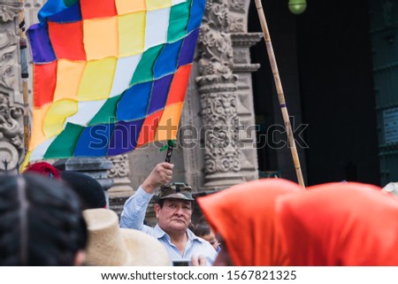 Man raising Tahuantinsuyo flag at Corpus Christi Cajamarca Peru ceremony