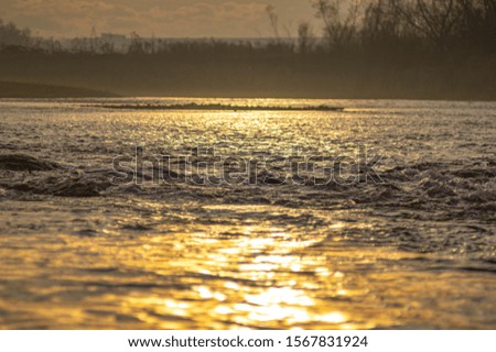 Waves at sunset on the river water close-up