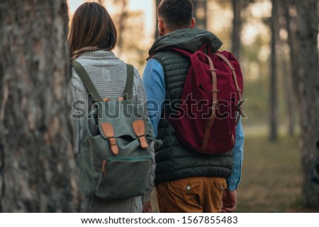 Young couple with backpackers exploring nature together