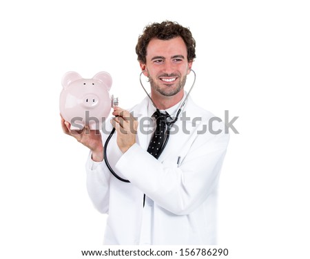 Healthcare reform concept Ã¢Â?Â? smiling male doctor holding a piggy bank and listening it with stethoscope, isolated on a white background . Medical insurance and reimbursement. Health system finances. 
