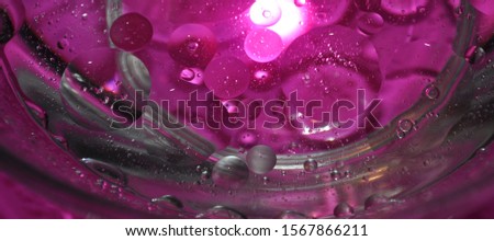 Oil bubbles in water closeup.