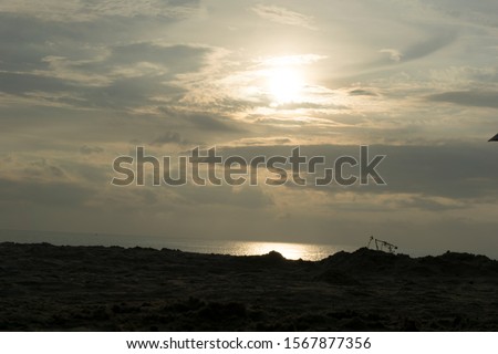 Beautiful dawn, morning sun rises by the sea. Scenic beach, coastline, rocks, cloudscape and skyline photography. Sunrise during the early hours of a summer morning by the beach. 