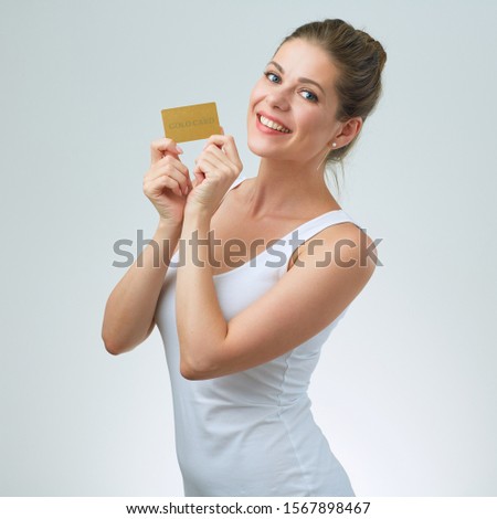 Smiling woman in white strap vest holding credit card. isolated female portrait.