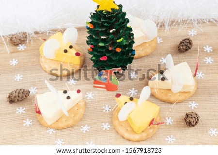 Festive food for the year of white mouse (rat). Cheese appetizer. Mice around new year tree. Christmas mood.