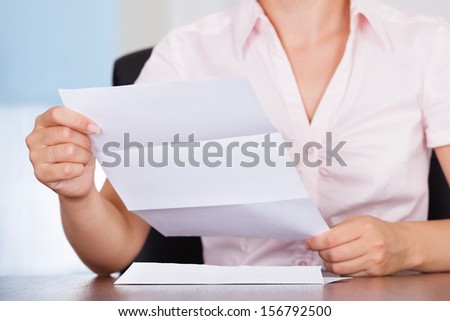 Closeup Of Young Businesswoman Holding Envelope With Letter