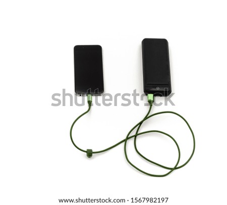 power bank and green cable used to charge the mobile phone