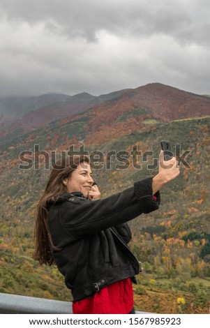young girl with her cell phone taking a picture