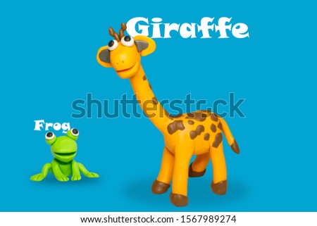 Statues like cute animals for children, like children's toys. Molding from plasticine to enhance children's learning skills. Cartoon characters, frogs and giraffes isolated on blue background.