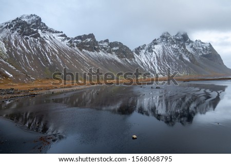 Landscape of Vesturhorn mountains with reflections in Southeast Iceland during winter time.	