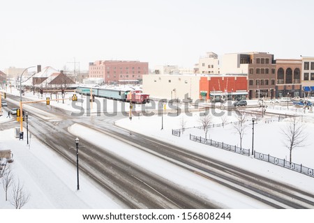 A snowstorm passes thru fargo, North dakota in winter. Royalty-Free Stock Photo #156808244