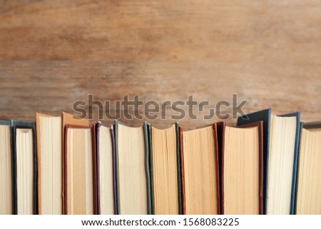 Collection of old books on wooden background