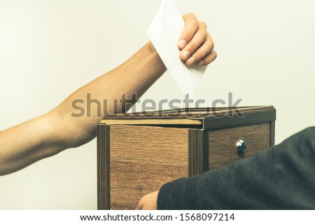 choice vote man puts a piece of paper in the box