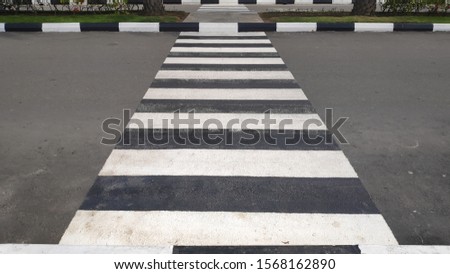 pedestrian crossing or zebra cross on aspalt road