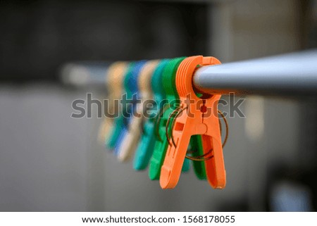 Colorful plastic clothespin hang on the line.