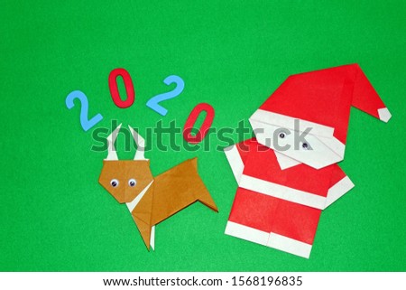 Origami Christmas paper art : Santa Claus and Reindeer, Merry Christmas and Happy New year. Copy space