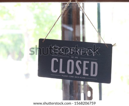 closed sign hanging in shop door
