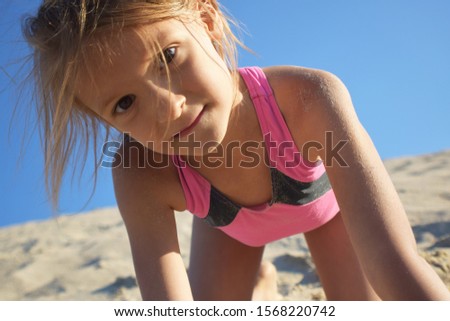 girl playing on the beach during summer vacation by the sea