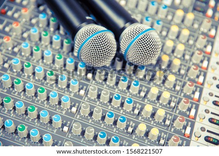 Microphones on the sound mixer in the studio for recording, editing, and sound system control concept.
