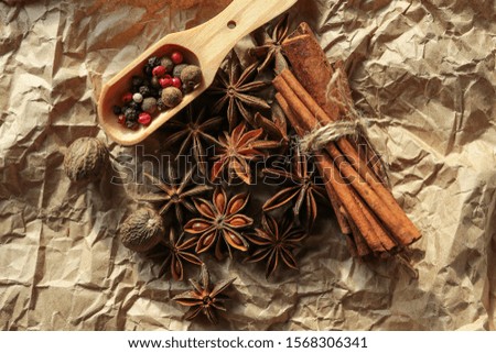 spices on craft paper: cinnamon, nutmeg, anise,  pepper