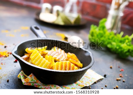 fried potato in pan, fried potato with salt and spice, stock photo