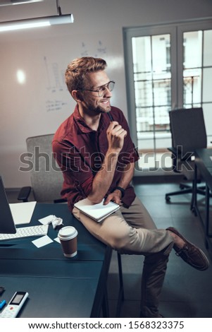 Smiling male worker going to take notes stock photo