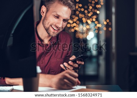 Smiling male worker writing in notebook stock photo