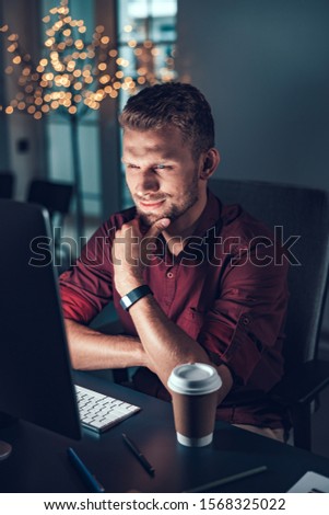 Waist up of businessman looking attentively on computer screen stock photo