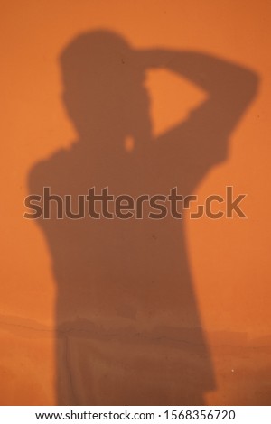 silhouette photographer on the wall