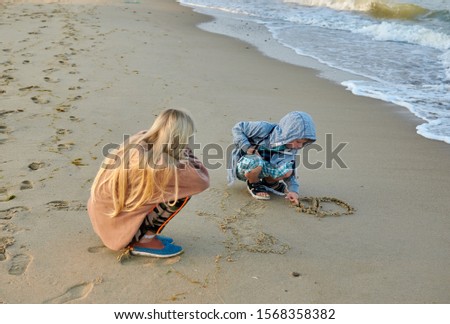 brother and sister in the evening on the seashore