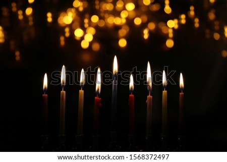 Religion image of jewish holiday Hanukkah background with menorah (traditional candelabra) and candles Royalty-Free Stock Photo #1568372497