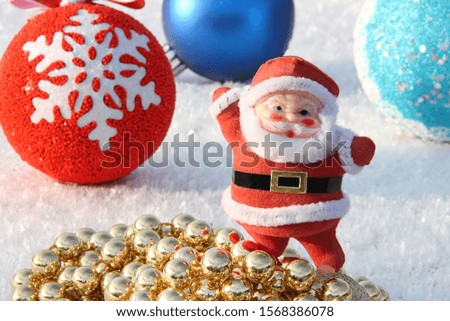 Christmas toy Santa Claus with golden balls on a background of red and blue balls