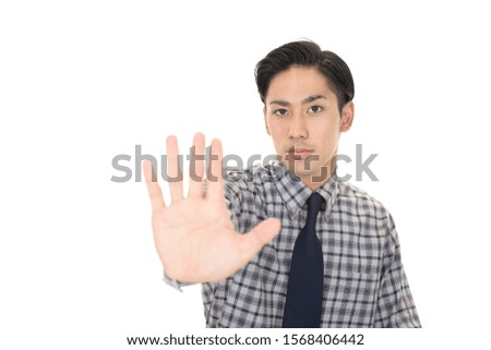 Businessman making stop sign isolated on white background.