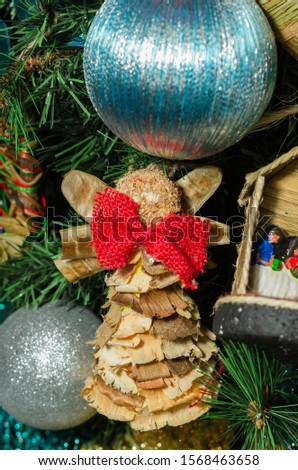Craft decorations for Christmas tree, handmade with splinter of wood and straw, Christmas angel.