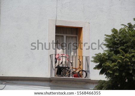 Window with balcony in white building