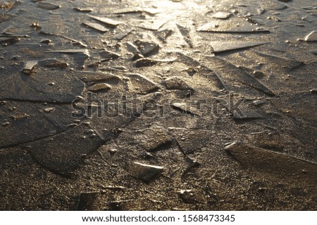 Photo of an ice surface with dents.
