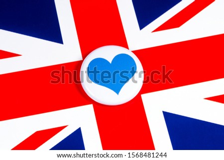 A blue heart symbol pictured over the flag of the United Kingdom.