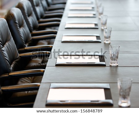 The boardroom table is set for the Annual General Meeting Royalty-Free Stock Photo #156848789