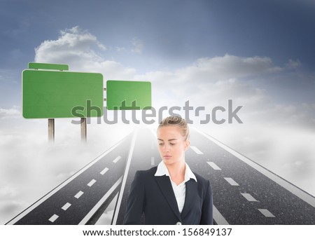 Composite image of blonde businesswoman looking down standing on streets floating in sky