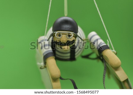 wooden puppet man stands in the air