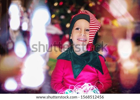 Happy  child  boy with Christmas lights