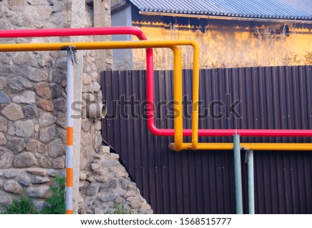 Gas steel pipes in a group along the fence in the countryside; live bright life concept