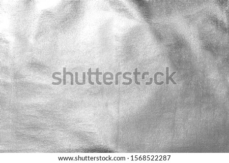 crumpled silver fabric, Christmas holiday background, place for text. Royalty-Free Stock Photo #1568522287