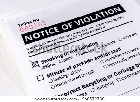 Notice of violation ticket for building bylaws. Bylaw infraction. No smoking in the building has a check mark. Strata or rental property management tool to warn about smoking, parking and recycling. 