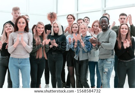 group of young people applauding . photo with copy space. Royalty-Free Stock Photo #1568584732