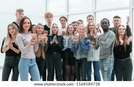 group of young people applauding . photo with copy space. Royalty-Free Stock Photo #1568584738